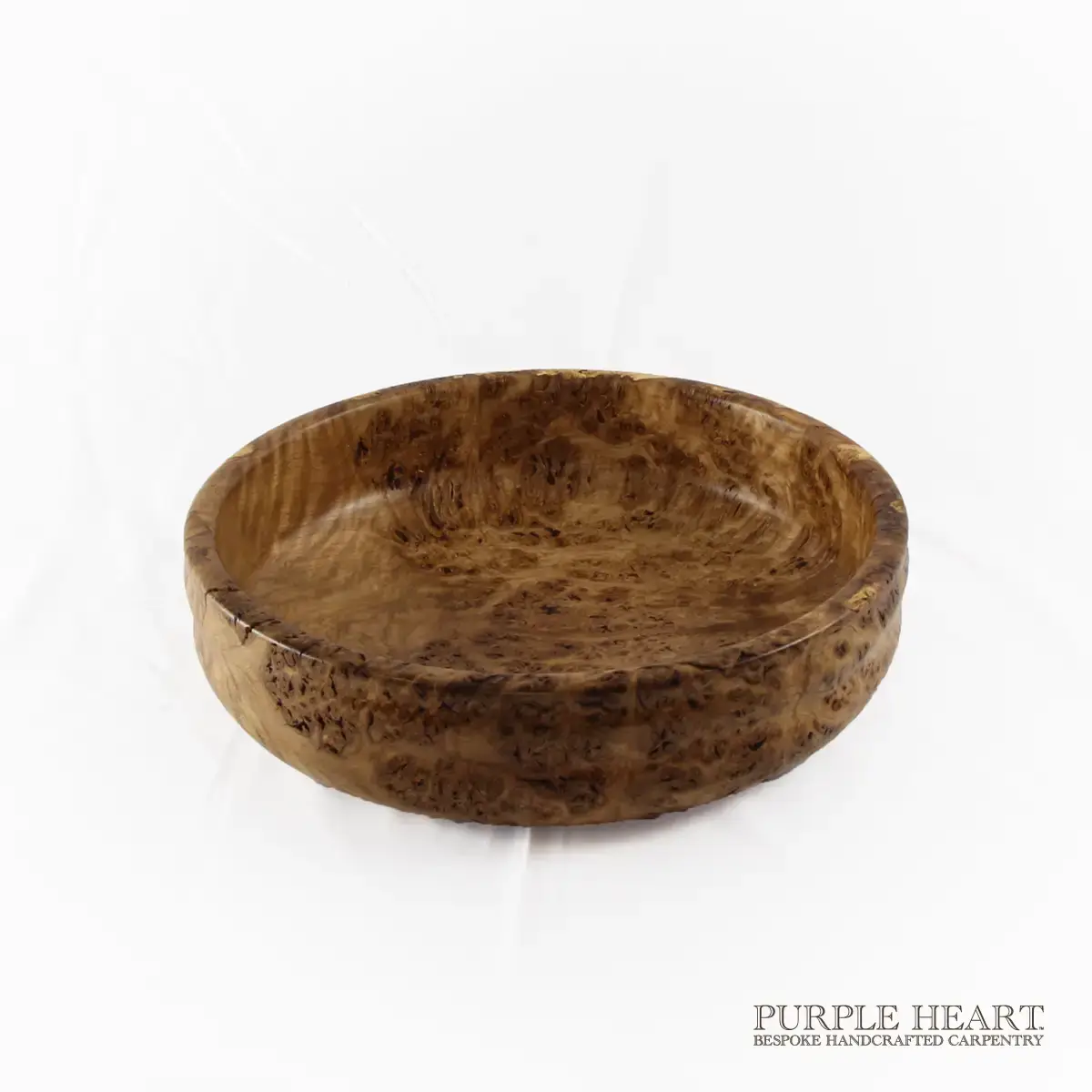 Handcrafted rare burr elm wood bowl with swirling grain and rich golden-brown natural wood patterns