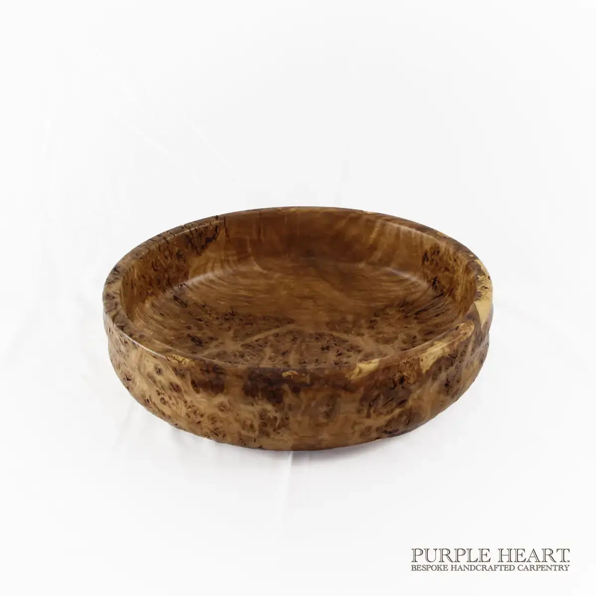 Handcrafted rare burr elm wood bowl with swirling grain and rich golden-brown natural wood patterns