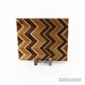 Handcrafted ash, cherry, maple and walnut chevron wooden chopping board with geometric hardwood pattern