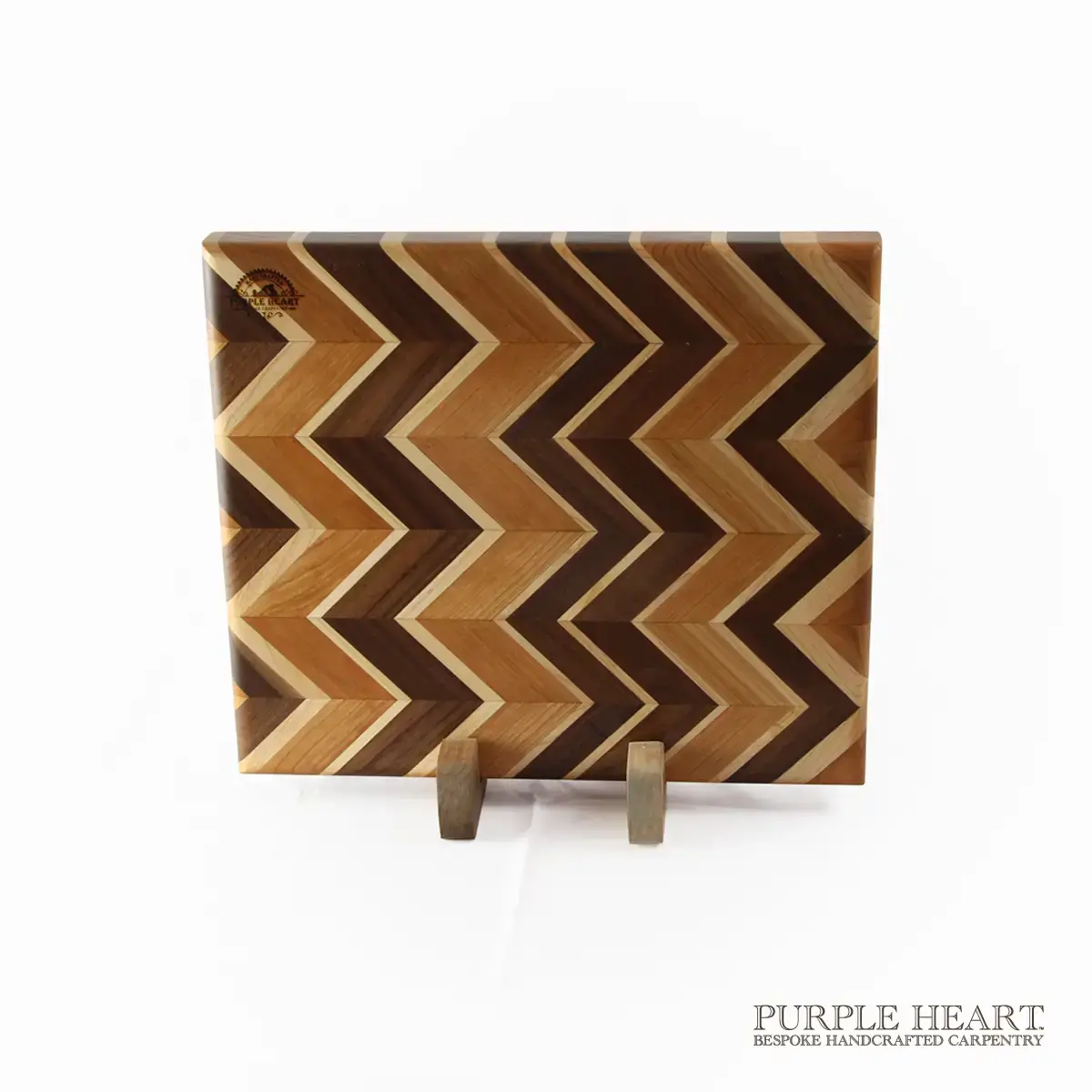 Handcrafted ash, cherry, maple and walnut chevron wooden chopping board with geometric hardwood pattern