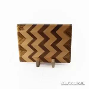 Handcrafted beech, walnut and zebrawood chevron wooden chopping board with geometric hardwood pattern