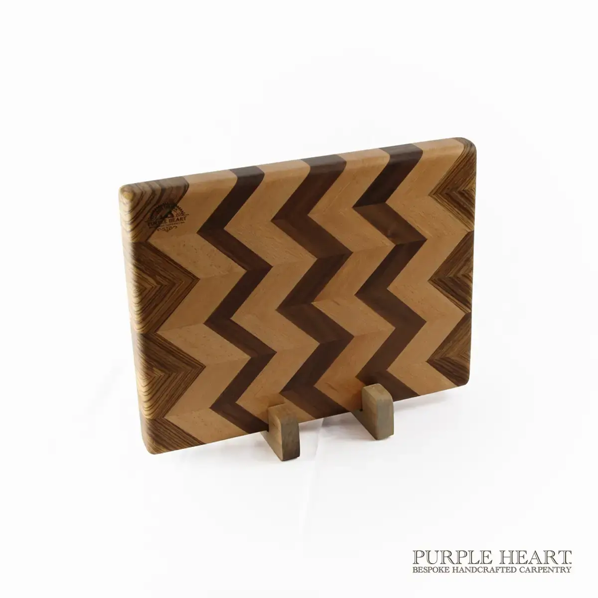 Handcrafted beech, walnut and zebrawood chevron wooden chopping board with geometric hardwood pattern