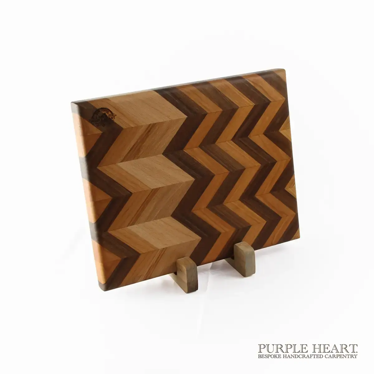 Handcrafted ash, beech and walnut chevron wooden chopping board with geometric hardwood pattern