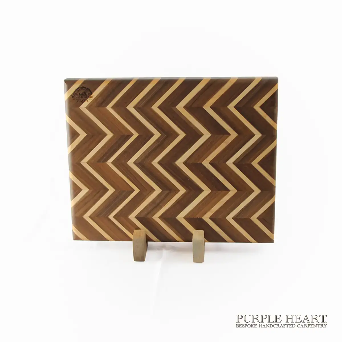 Handcrafted ash and walnut chevron wooden chopping board with geometric zigzag hardwood pattern