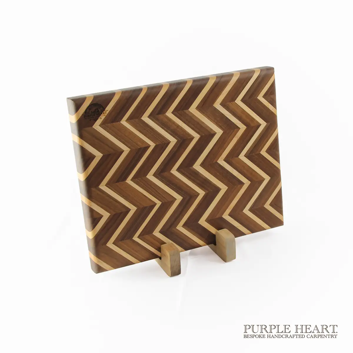 Handcrafted ash and walnut chevron wooden chopping board with geometric zigzag hardwood pattern