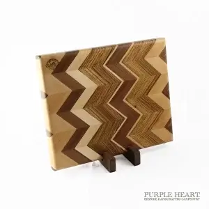 Handcrafted ash, cherry, walnut and zebra wood chevron wooden chopping board with geometric hardwood pattern