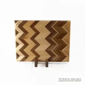 Handcrafted ash, cherry, beech, walnut and zebra wood chopping board with geometric hardwood pattern