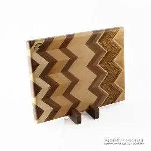 Handcrafted ash, cherry, beech, walnut and zebra wood chopping board with geometric hardwood pattern