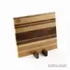 Handcrafted ash, cherry and walnut striped wooden chopping board with natural hardwood grain pattern